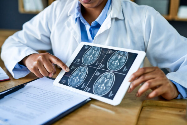 A doctor shows brain imaging to a patient